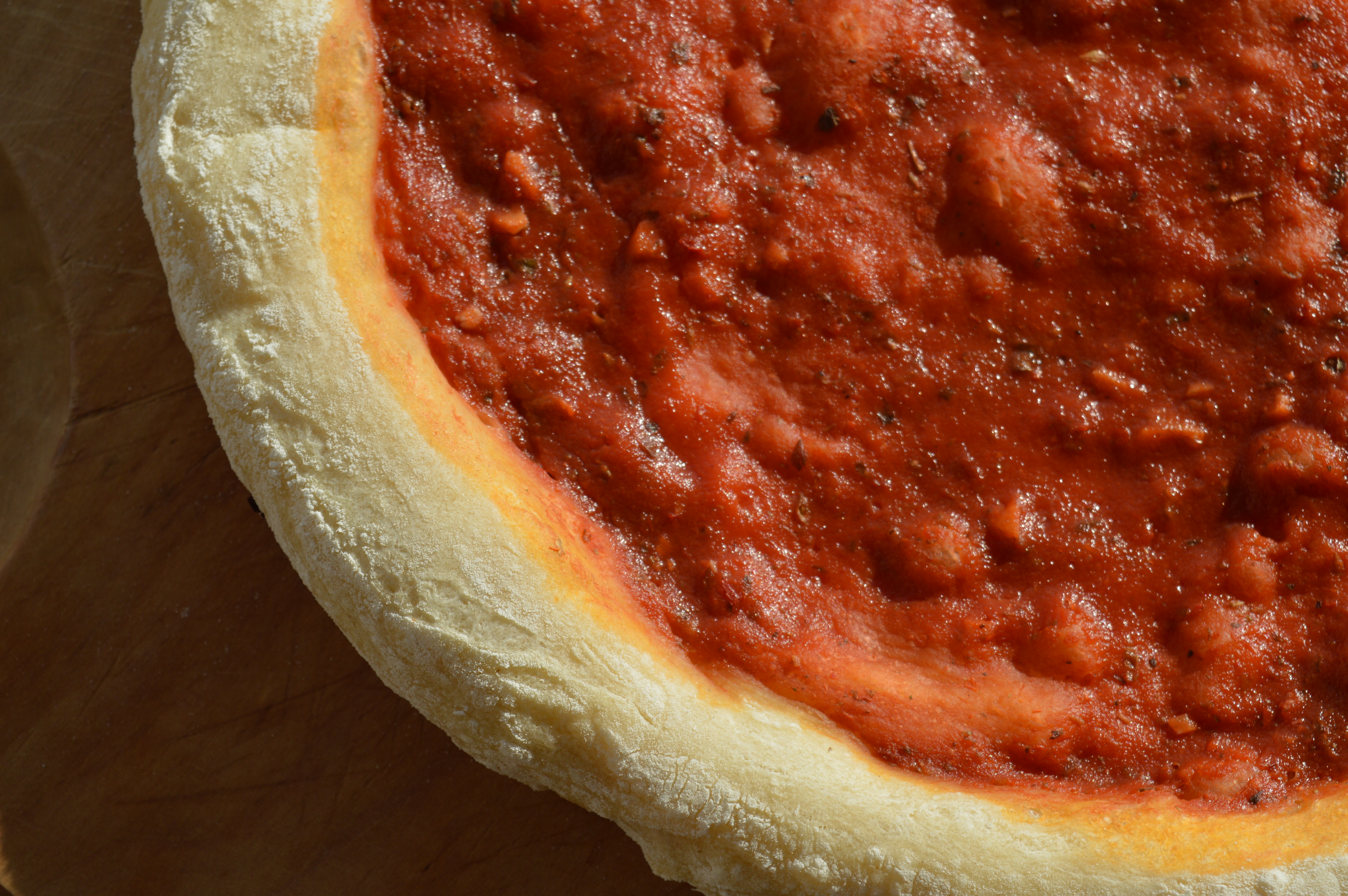 Prepizza casera con abundante salsa
